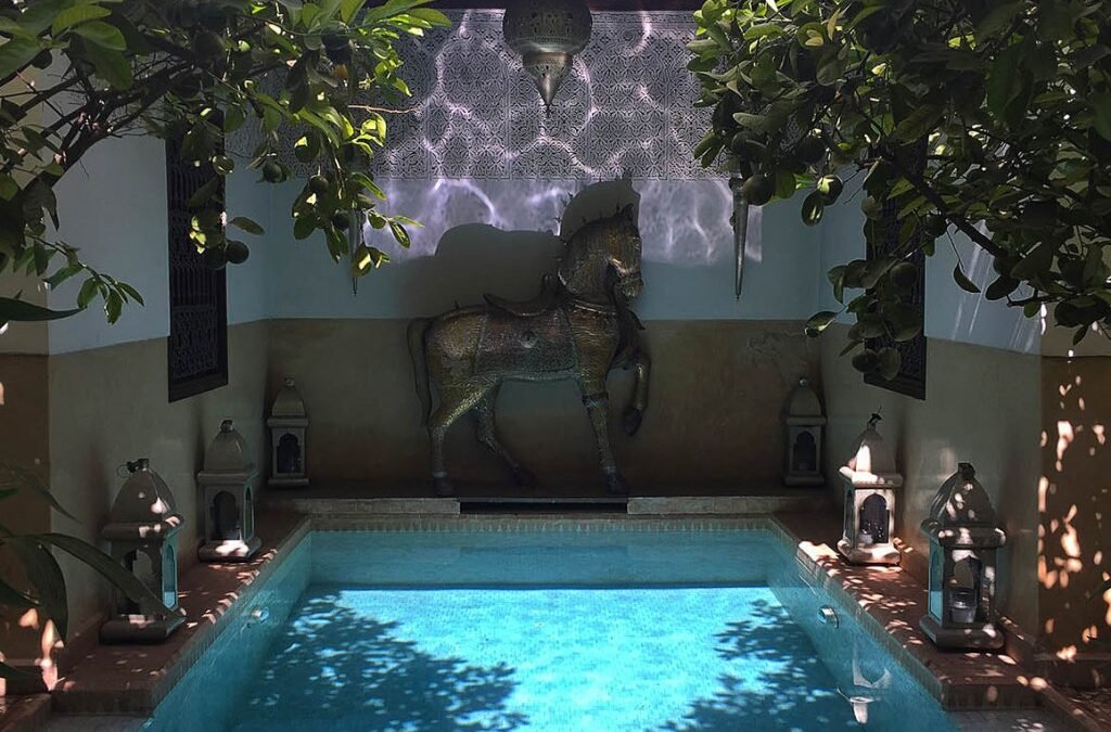 Riad Assakina courtyard pool with bronze horse statue
