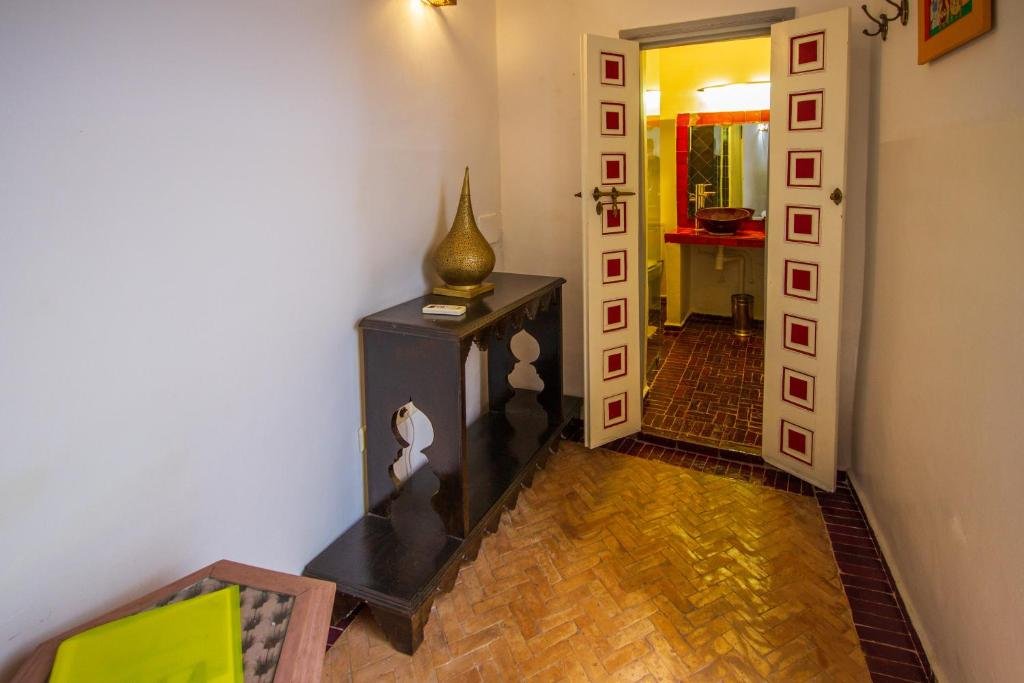 Painted wooden doors to a guest room, Riad les Jardins des Lilas